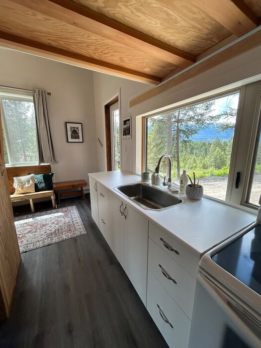 The kitchen sink under a large window, with the counter stretching the length of the house